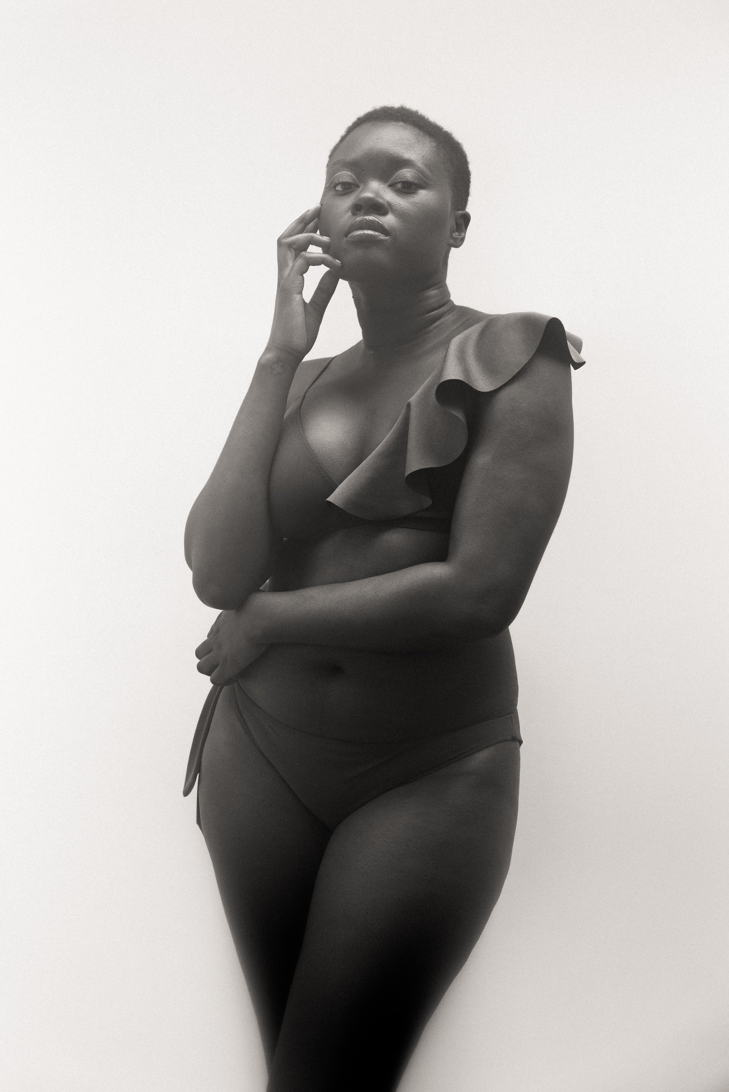 Elegant post-mastectomy bikini model wearing ENO adaptive swimsuit — sustainable, beautifully designed for one-breasted women. breast cancer, single mastectomy